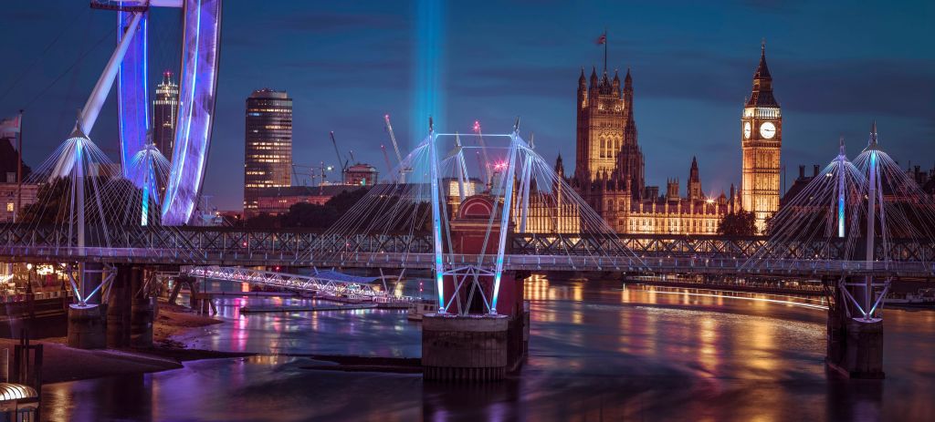 Night view of the London Eye, Golden Jubilee bridge and Westminster, London, UK